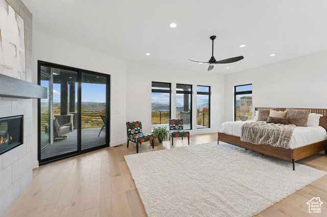 2280 East Outlaw Road, Unit 56 Kamas, UT 84036 - Photo 21 of 59 Bedroom featuring recessed lighting, light wood-style floors, access to outside, a fireplace, and ceiling fan