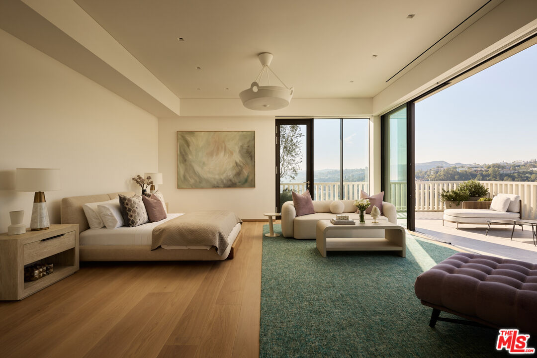 9255 Doheny Road, Unit PH West Hollywood, CA 90069 - Photo 14 of 24 a living room with furniture and a large window