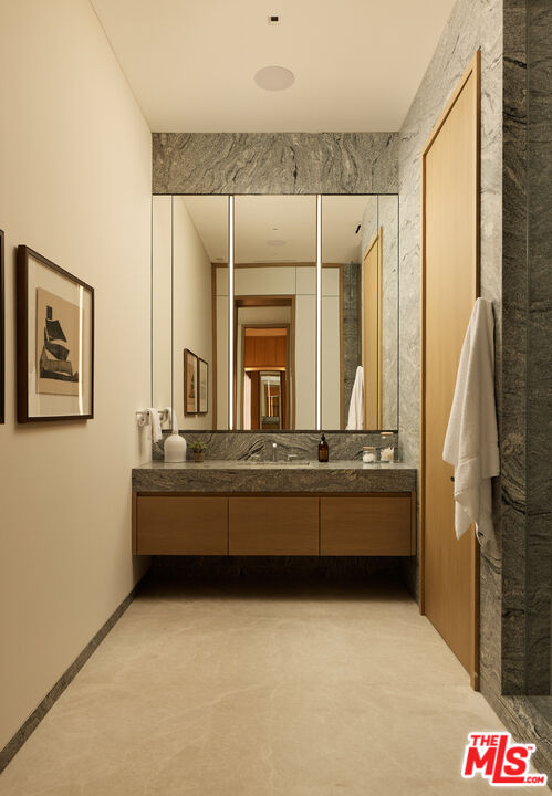 9255 Doheny Road, Unit PH West Hollywood, CA 90069 - Photo 16 of 24 a bathroom with a tub a sink and a large mirror