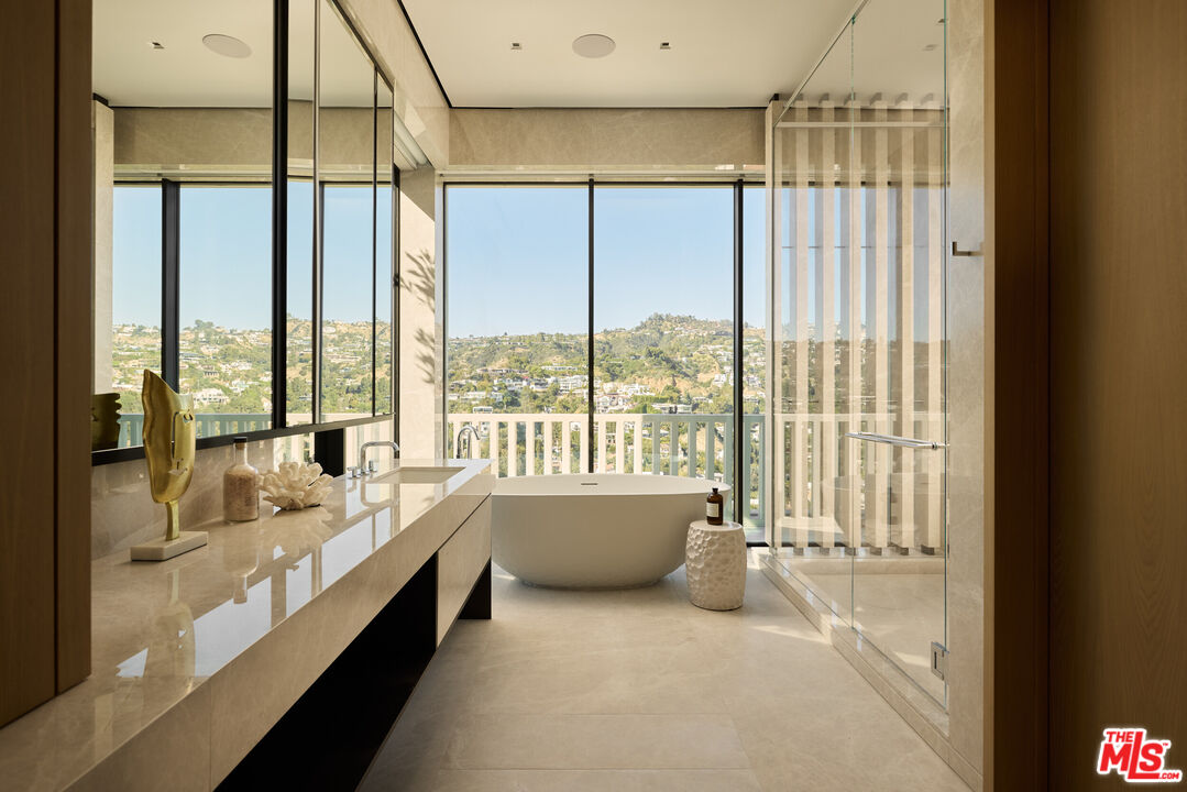 9255 Doheny Road, Unit PH West Hollywood, CA 90069 - Photo 18 of 24 a large room with a large window and a bed
