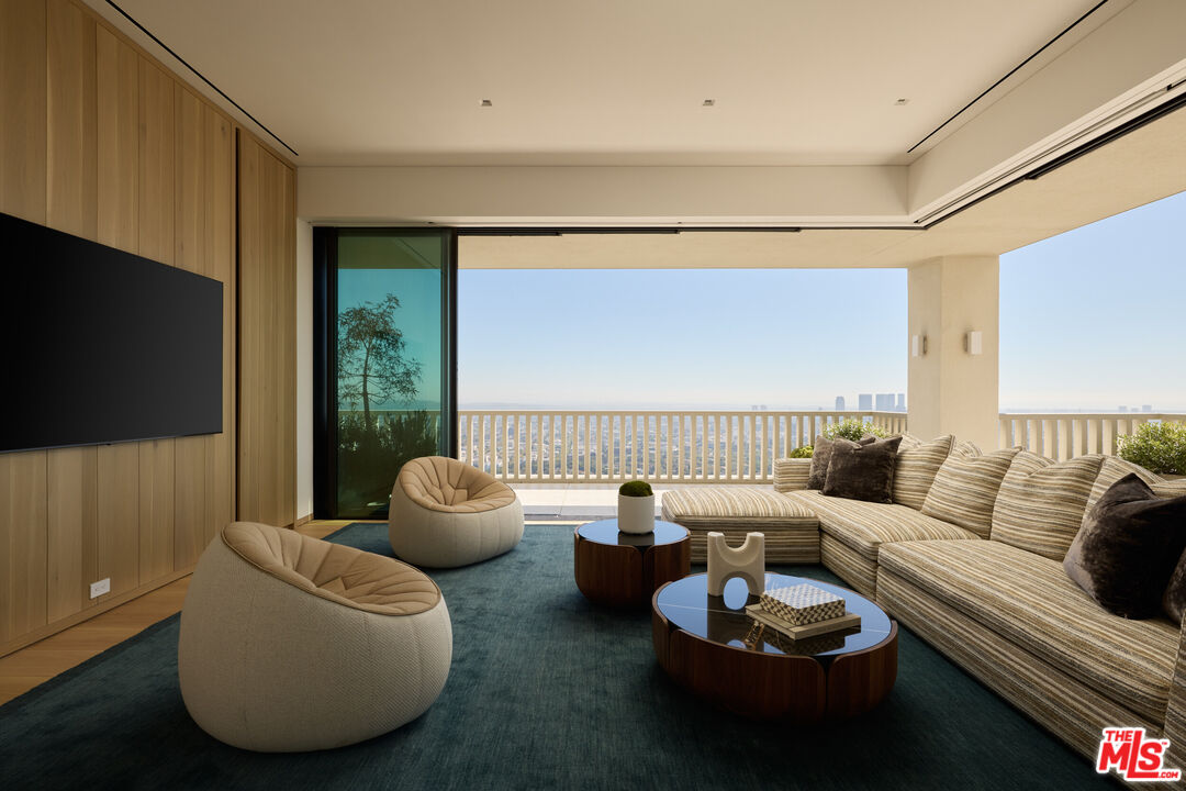 9255 Doheny Road, Unit PH West Hollywood, CA 90069 - Photo 20 of 24 a living room with furniture and a flat screen tv