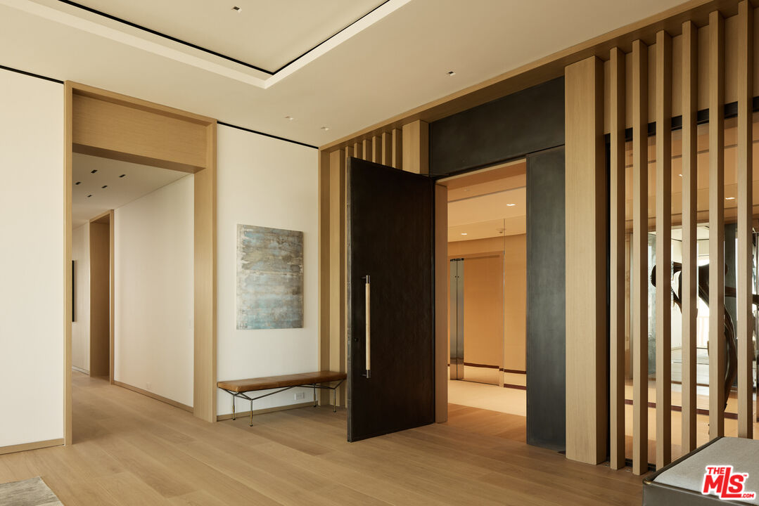 9255 Doheny Road, Unit PH West Hollywood, CA 90069 - Photo 2 of 24 a view of a hallway with wooden floor and staircase