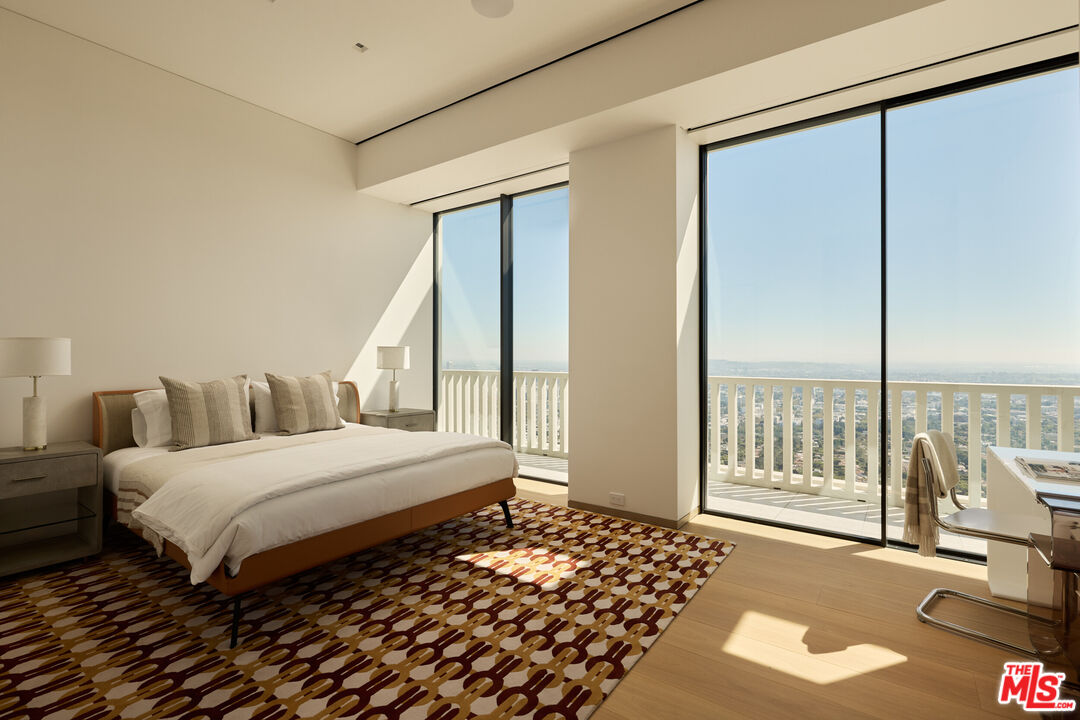 9255 Doheny Road, Unit PH West Hollywood, CA 90069 - Photo 22 of 24 a bedroom with a bed and glass door