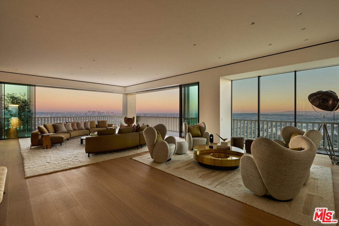 9255 Doheny Road, Unit PH West Hollywood, CA 90069 - Photo 5 of 24 a living room with furniture and floor to ceiling window