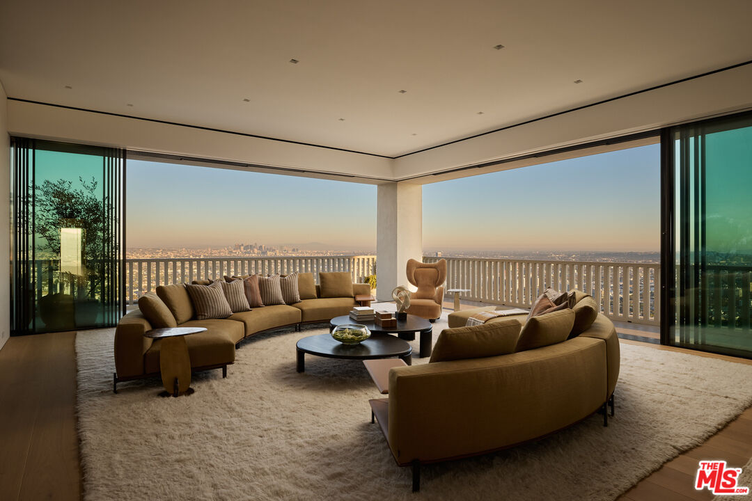 9255 Doheny Road, Unit PH West Hollywood, CA 90069 - Photo 6 of 24 a living room with furniture and a large window