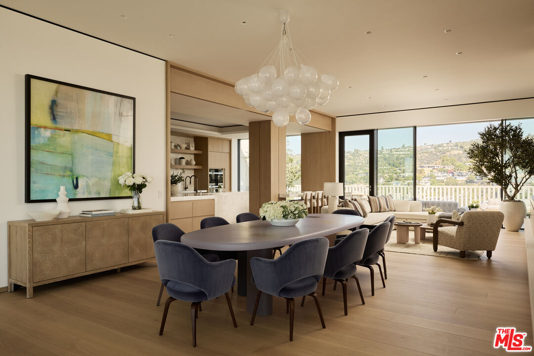 9255 Doheny Road, Unit PH West Hollywood, CA 90069 - Photo 8 of 24 a view of a dining room with furniture and wooden floor