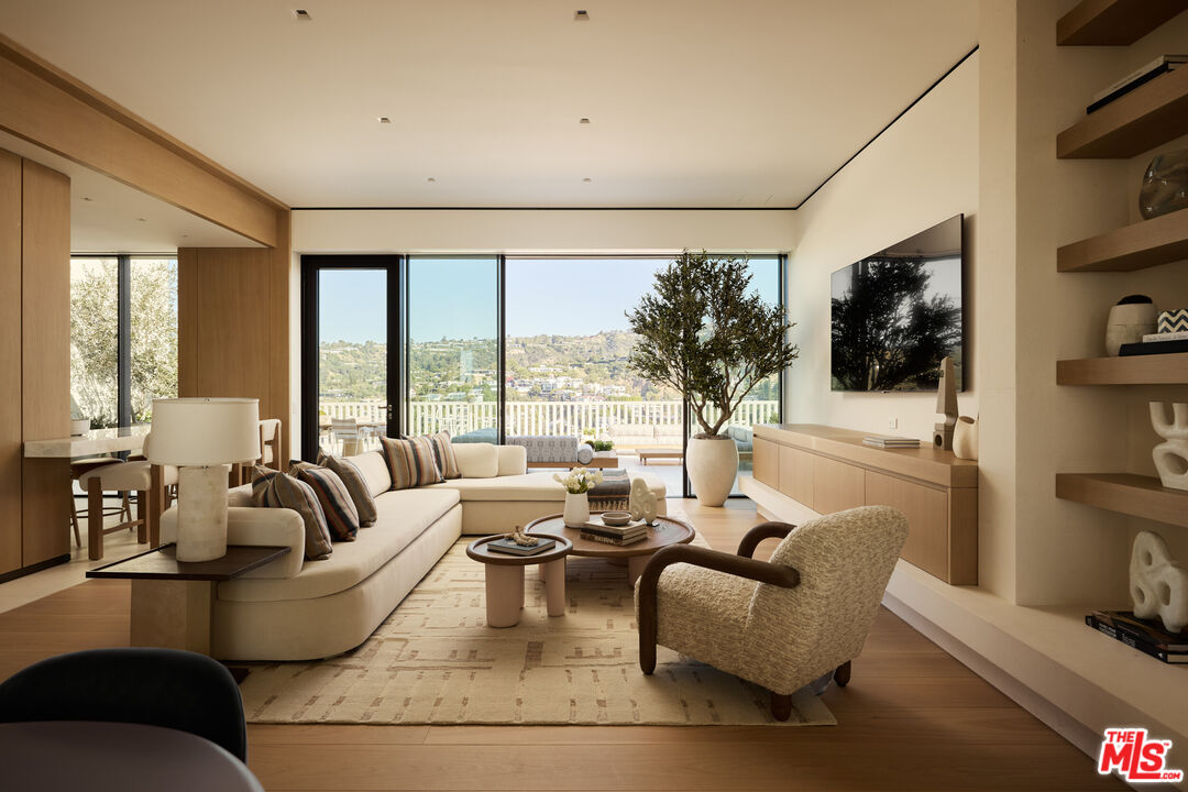 9255 Doheny Road, Unit PH West Hollywood, CA 90069 - Photo 9 of 24 a living room with furniture large window and flat screen tv