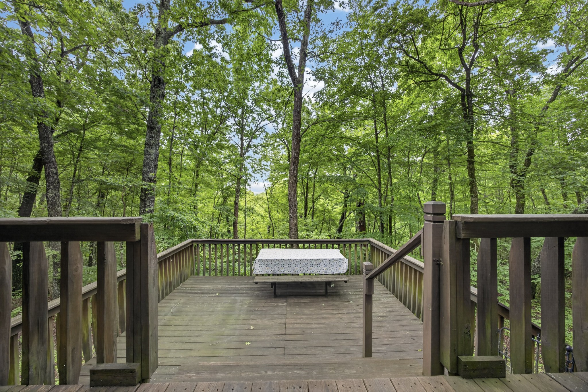 55214 Maynard Ridge Lane Crawford, TN 38554 - Photo 21 of 32 a view of a balcony with wooden floor and bench