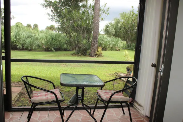 a view of chairs and table in balcony