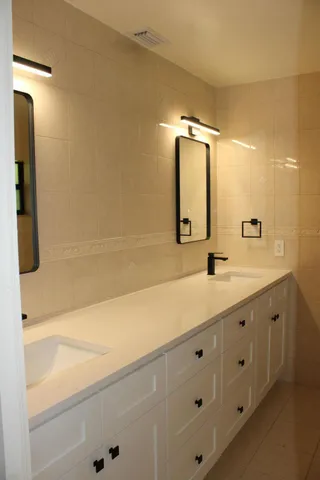 a bathroom with a double vanity sink and mirror