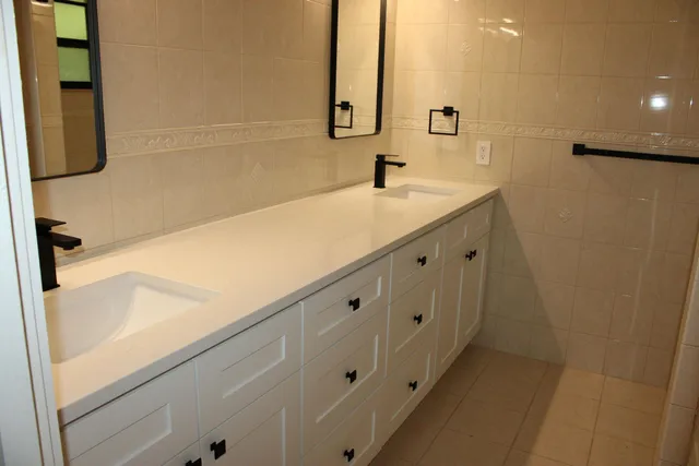 a bathroom with a double vanity sink and mirror