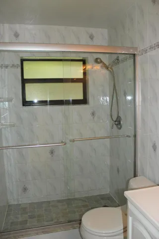 a bathroom with a toilet and a shower