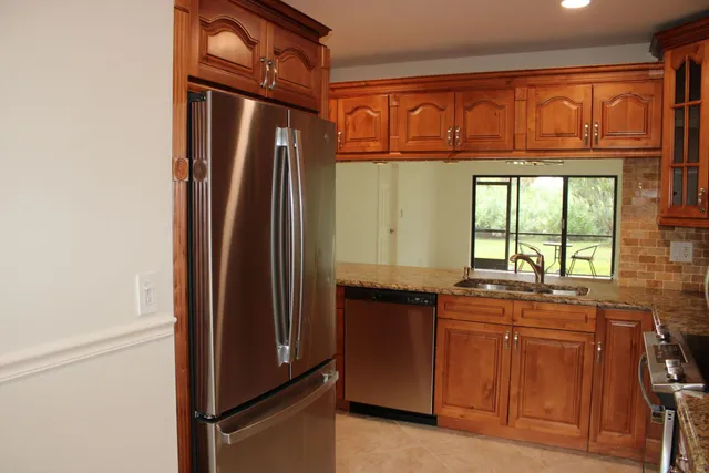 a kitchen with a refrigerator and a sink