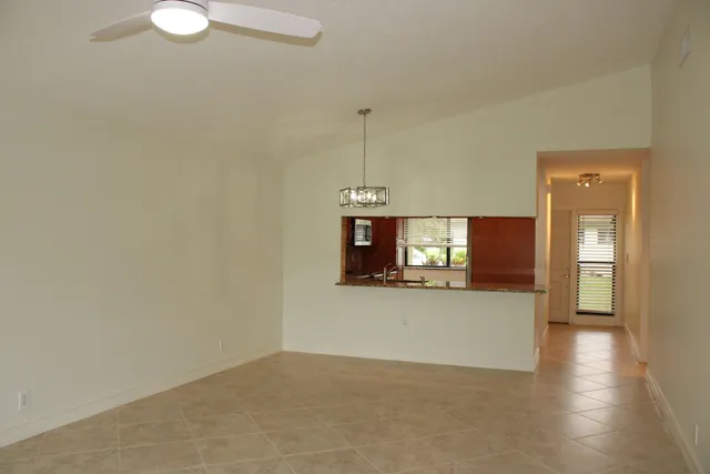 a view of a livingroom with wooden floor and a window