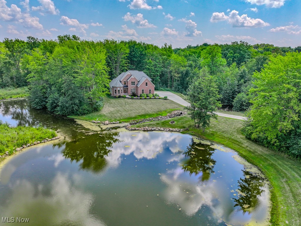 8675 Auburn Road Chardon, OH 44024 - Photo 2 of 35 Aerial view of property and surrounding area featuring a large body of water and a forest