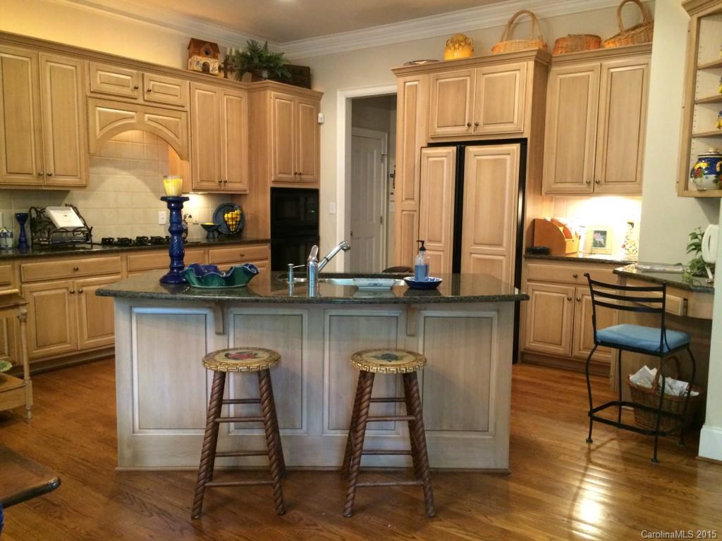 2138 Harris Road Charlotte, NC 28211 - Photo 5 of 17 a kitchen with stainless steel appliances granite countertop a stove top oven a sink and cabinets