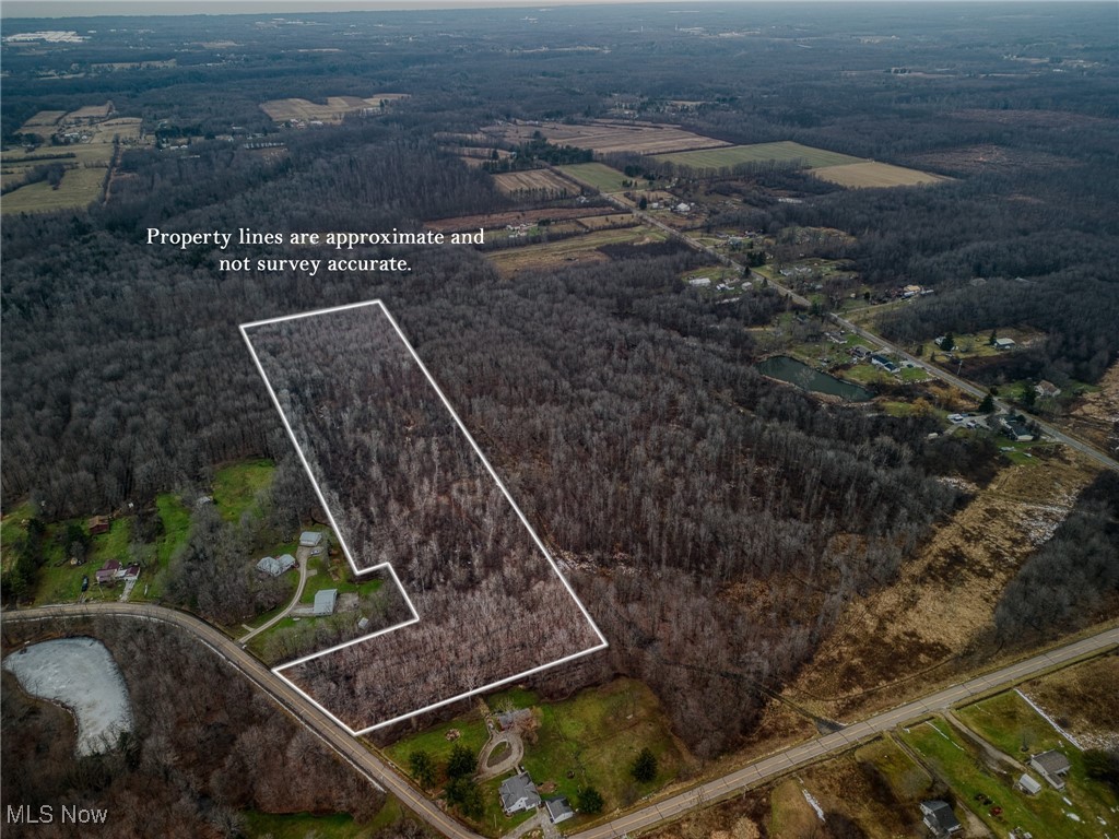15594 Moseley Road Madison, OH 44057 - Photo 2 of 7 Aerial view of property and surrounding area featuring property parcel outlined and rural landscape
