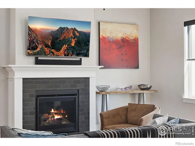 a living room with furniture a fireplace and wall painting