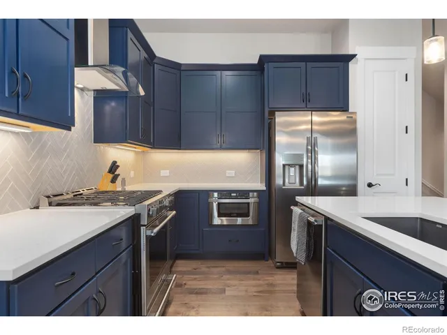a kitchen with a sink stove and refrigerator