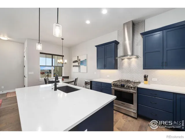 a kitchen with stainless steel appliances a sink stove and refrigerator