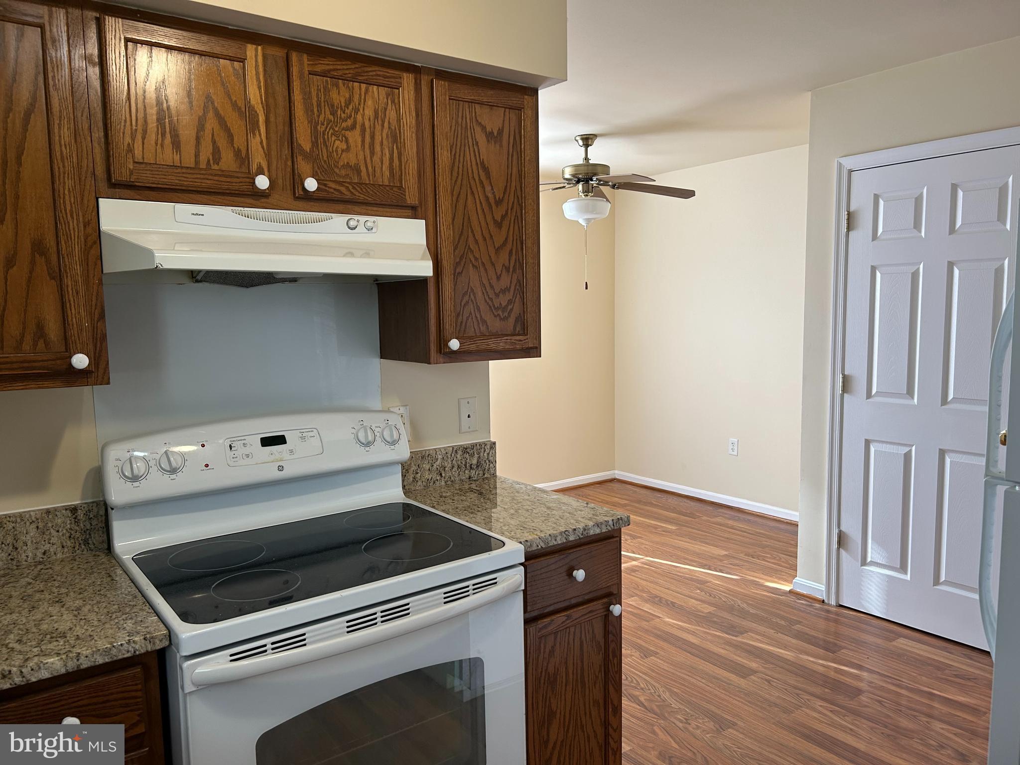 981 Main Avenue Hagerstown, MD 21740 - Photo 12 of 39 a kitchen with granite countertop a stove and a wooden floor