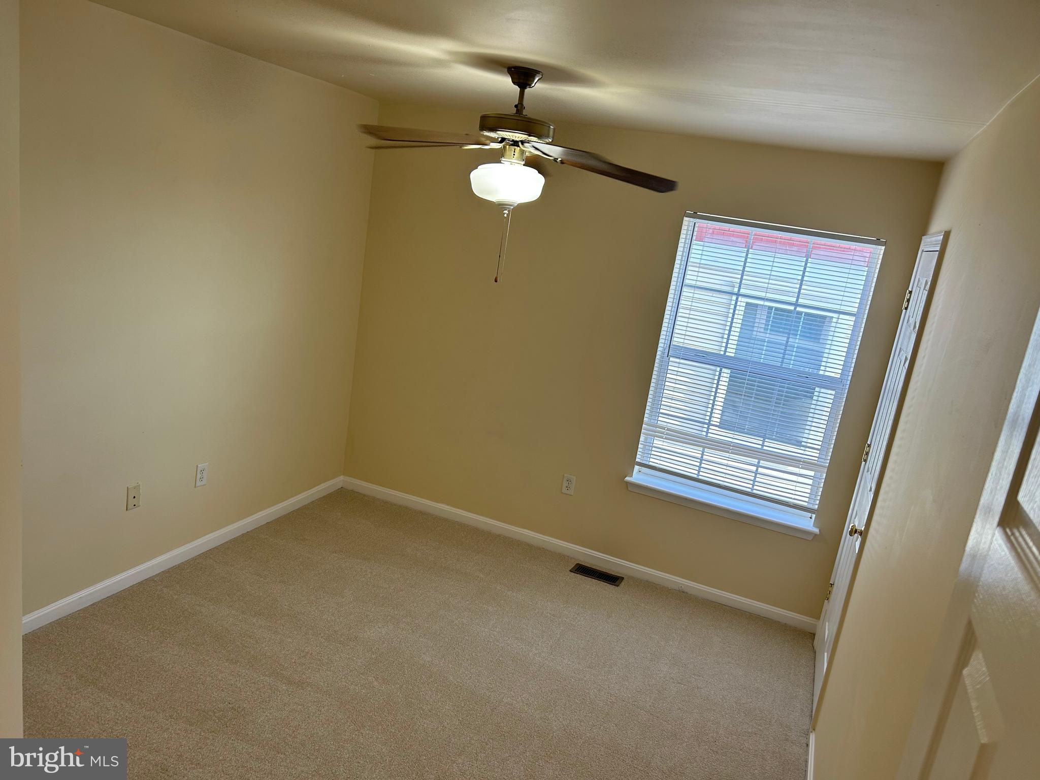 981 Main Avenue Hagerstown, MD 21740 - Photo 24 of 39 an empty room with a chandelier fan and windows