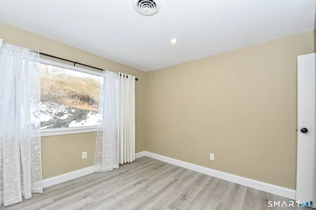 a bathroom with a toilet a sink a vanity and mirror