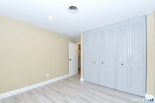a bathroom with a sink vanity mirror and toilet