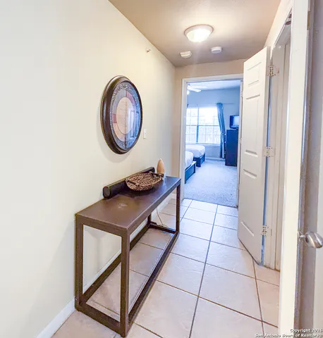 a bedroom with two beds and a chandelier