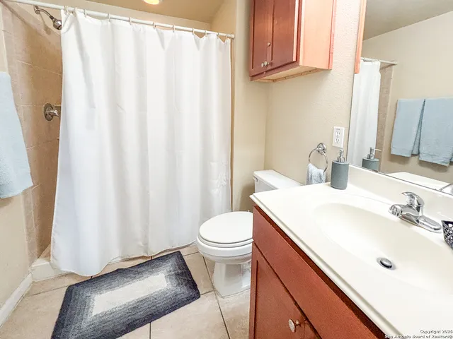 a bedroom with a bed and a flat tv screen on the dresser
