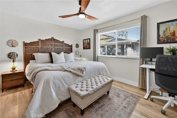 a bedroom with a bed window and a table