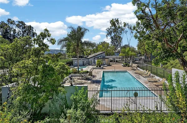 a backyard of a house with portable swimming pool and basket ball court