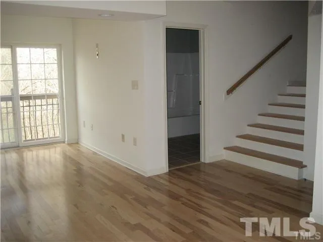 a view of an entryway with wooden floor and door