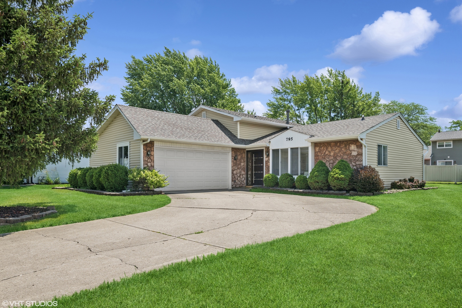 a front view of a house with a yard and garage