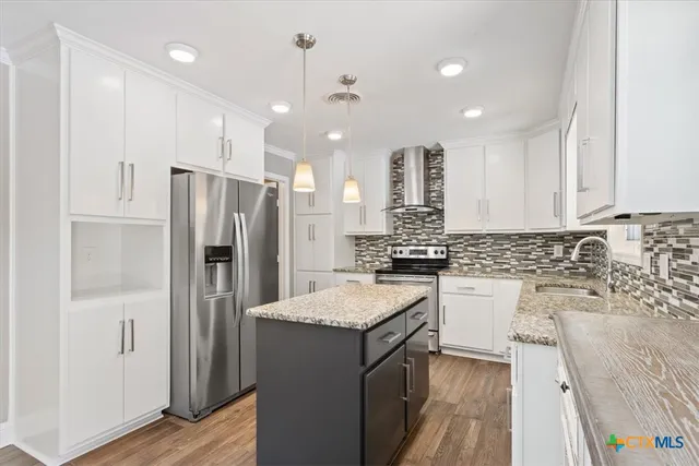 a kitchen with a refrigerator sink and fireplace