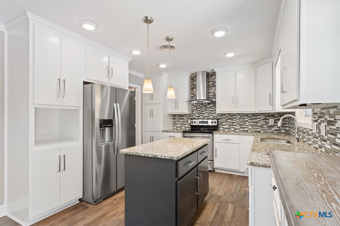 2810 Lilac Lane Temple, TX 76502 - Photo 12 of 40 a kitchen with a refrigerator sink and fireplace