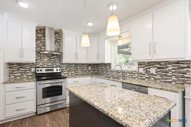 a kitchen with stainless steel appliances granite countertop a stove and a sink