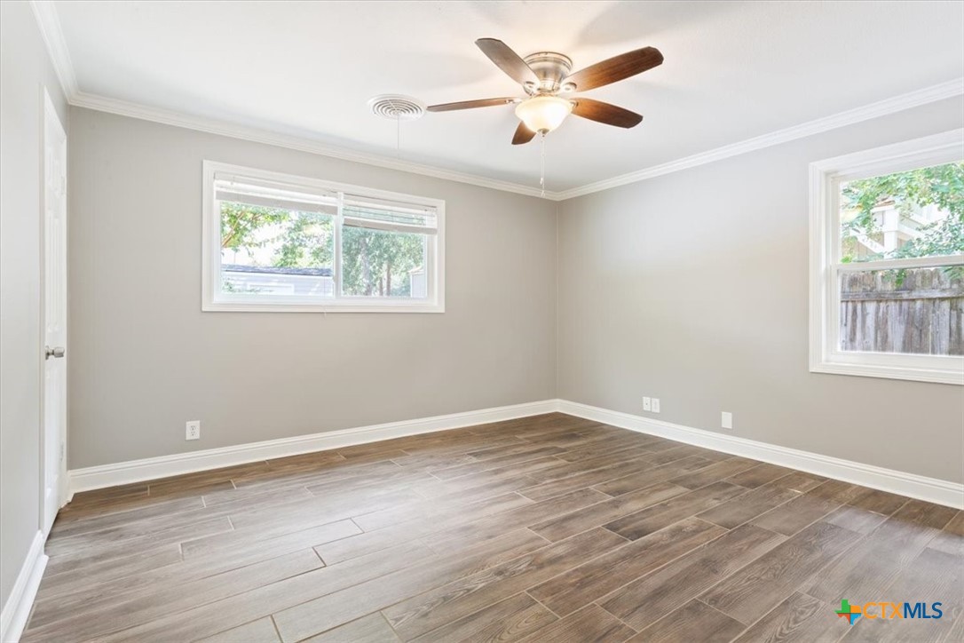 2810 Lilac Lane Temple, TX 76502 - Photo 15 of 40 an empty room with wooden floor and windows