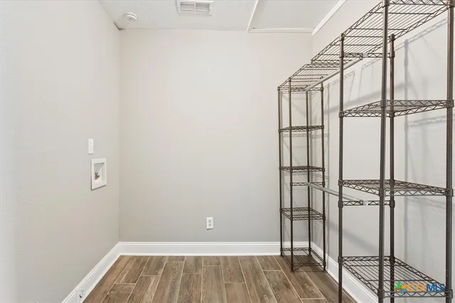 a view of a room with wooden floor
