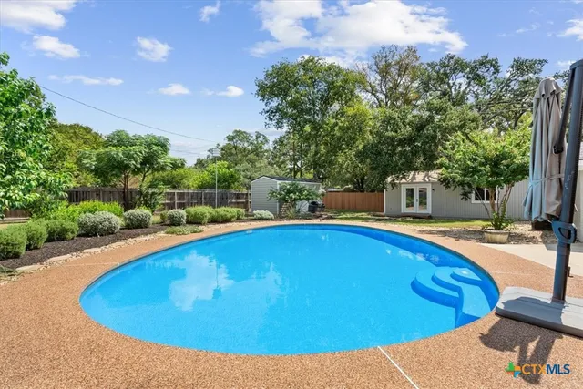 a view of a swimming pool with an outdoor space and seating area