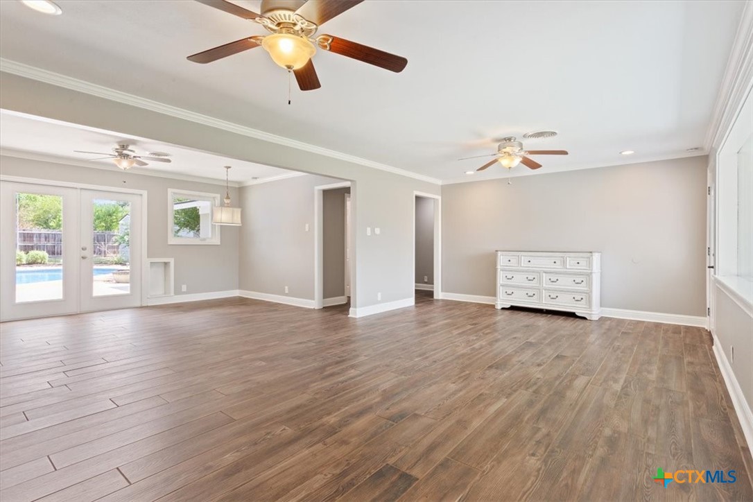 2810 Lilac Lane Temple, TX 76502 - Photo 8 of 40 a view of an empty room with wooden floor and a window