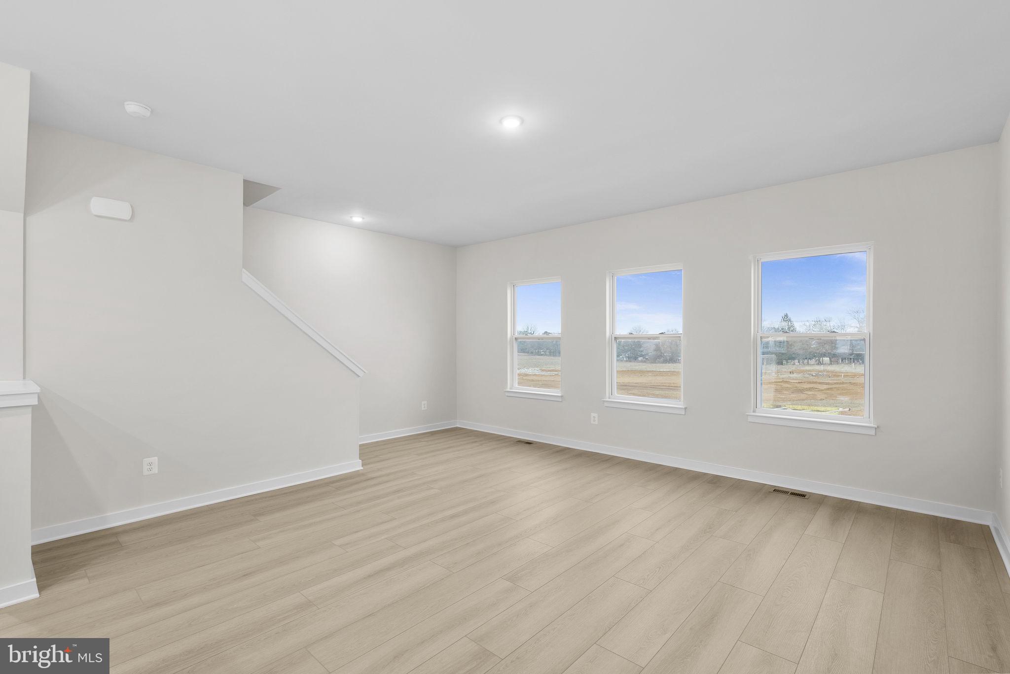 1523 Sumter Avenue Ranson, WV 25438 - Photo 11 of 50 an empty room with wooden floor and windows
