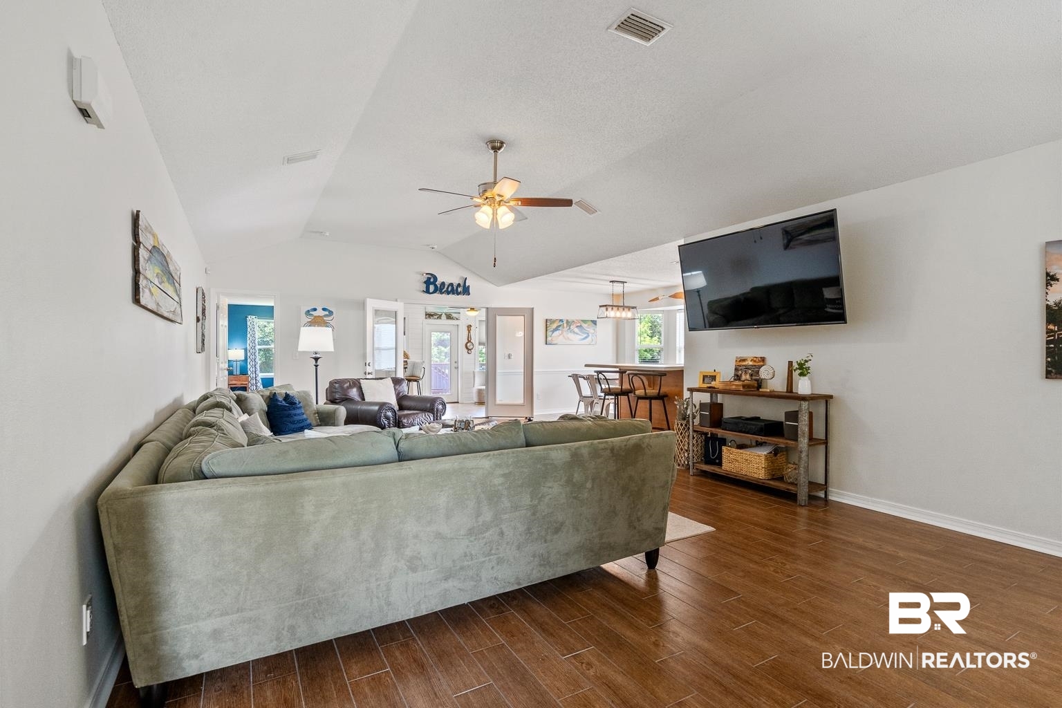 22764 Respite Lane Foley, AL 36535 - Photo 13 of 46 Living area featuring ceiling fan, dark wood finished floors, vaulted ceiling, and baseboards