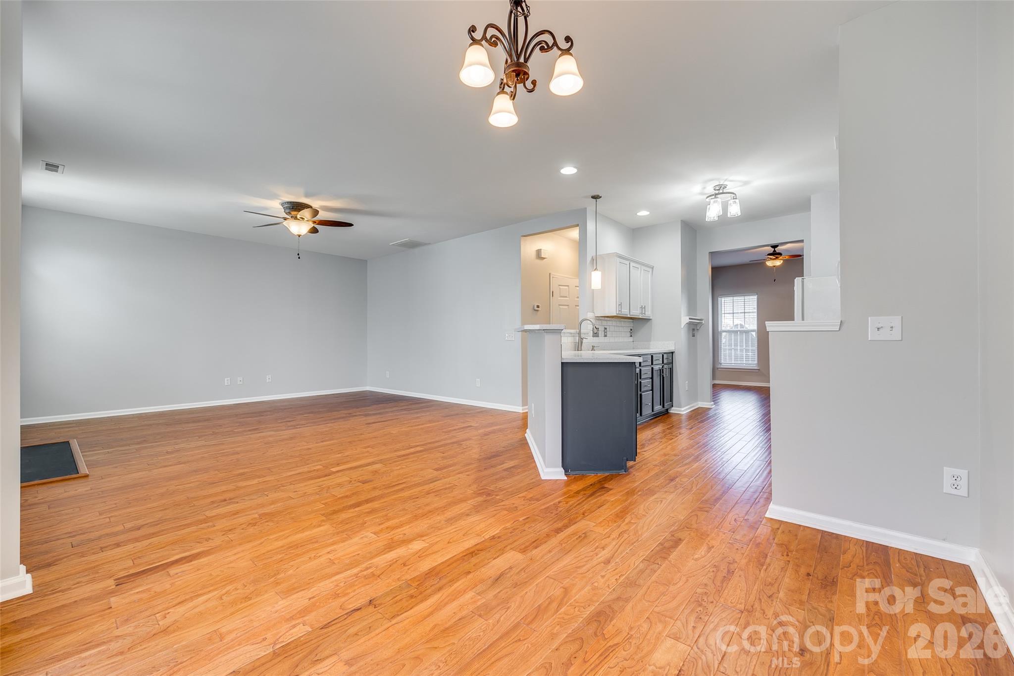 618 Bayou Circle Clover, SC 29710 - Photo 14 of 31 a view of an empty room and kitchen with wooden floor
