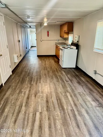 a view of a kitchen with a sink and dishwasher wooden floor