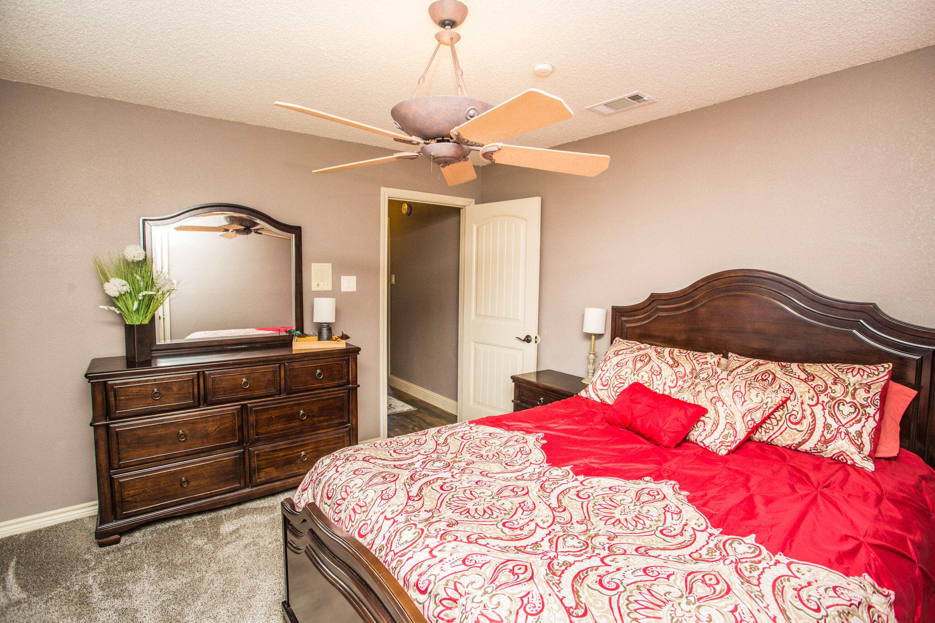 5202 85th Street Lubbock, TX 79424 - Photo 24 of 40 a bedroom with a bed and a dresser