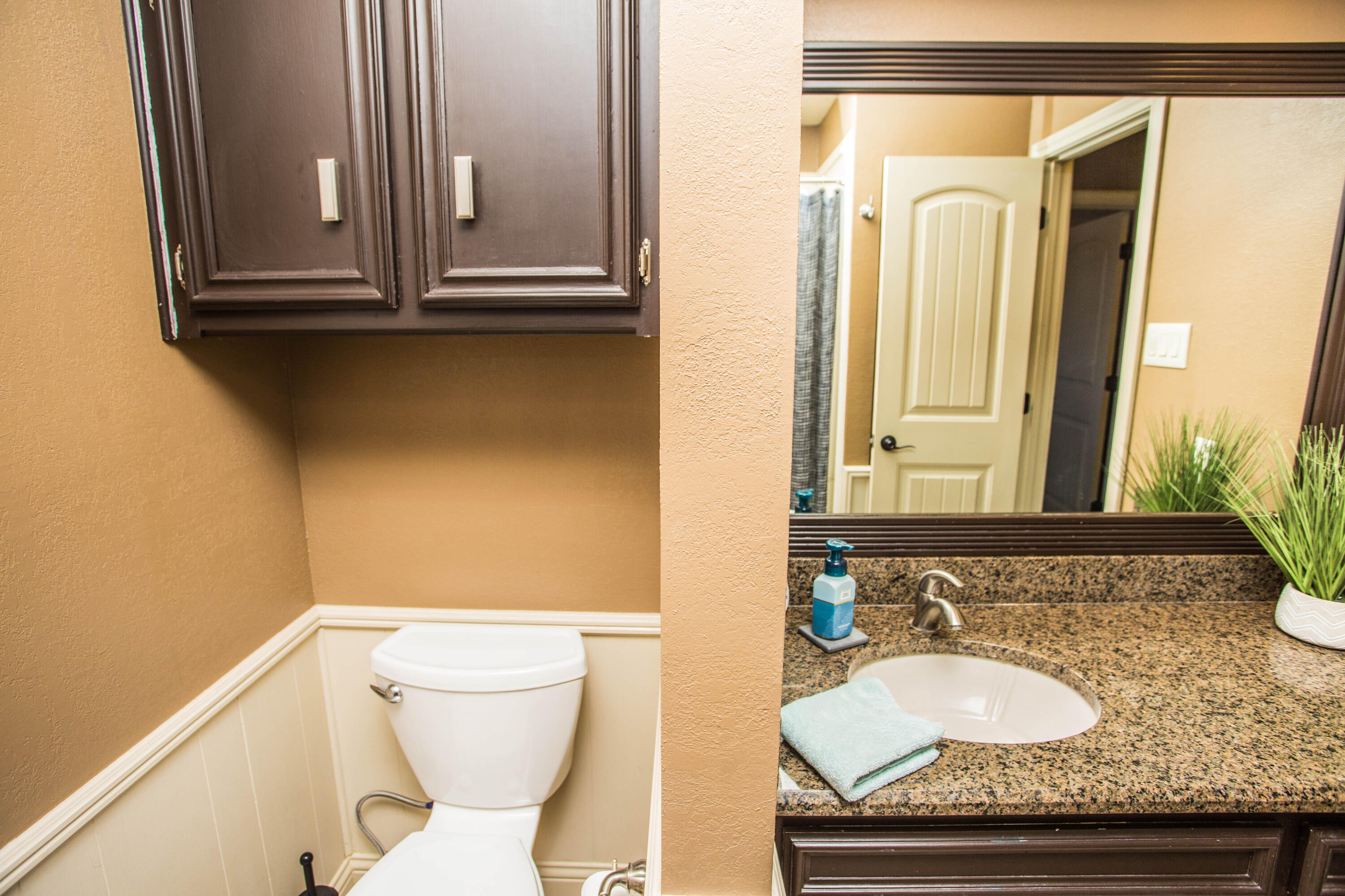 5202 85th Street Lubbock, TX 79424 - Photo 26 of 40 a bathroom with a granite countertop sink and a mirror