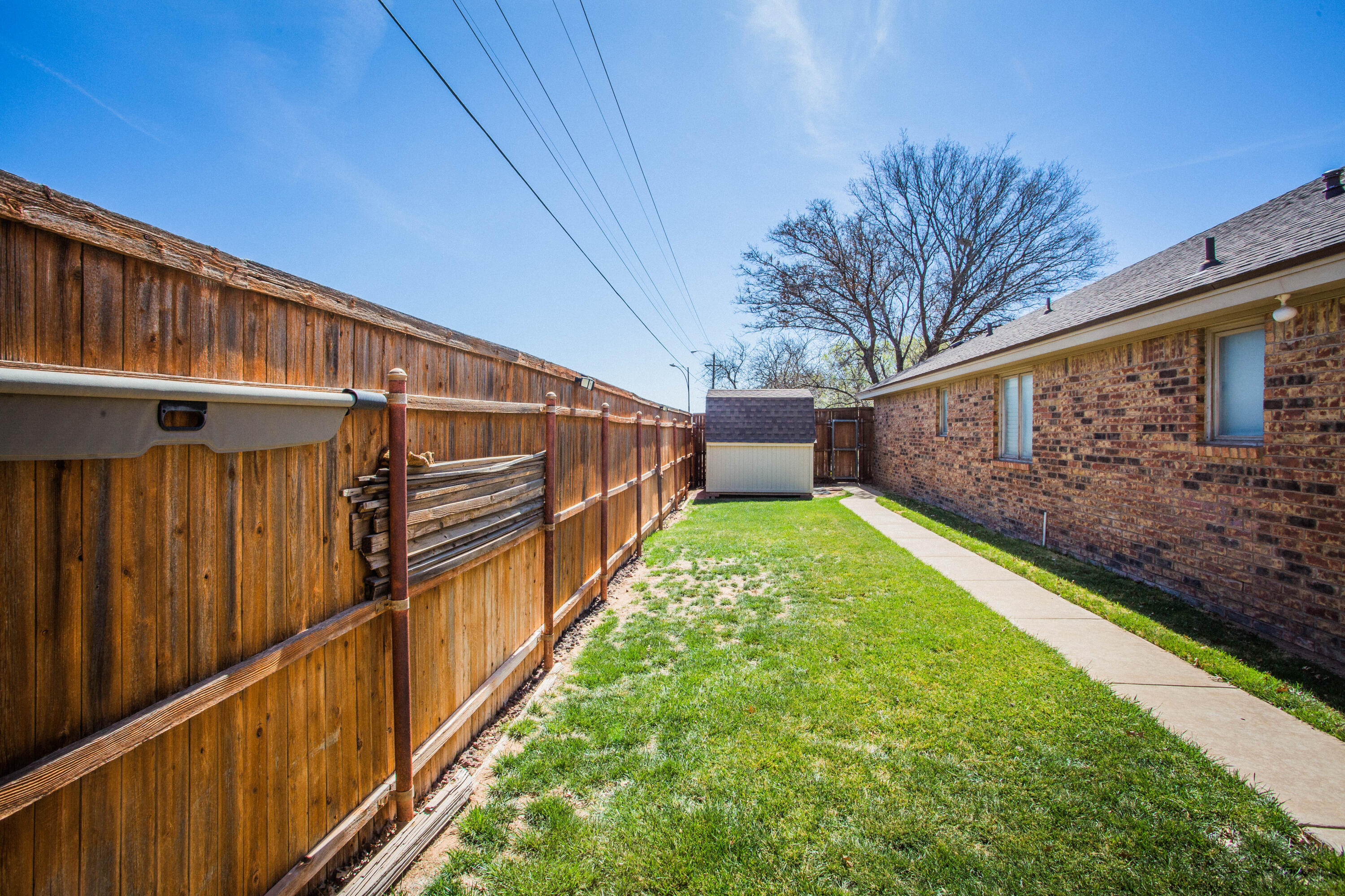 5202 85th Street Lubbock, TX 79424 - Photo 37 of 40 a view of a backyard with wooden fence
