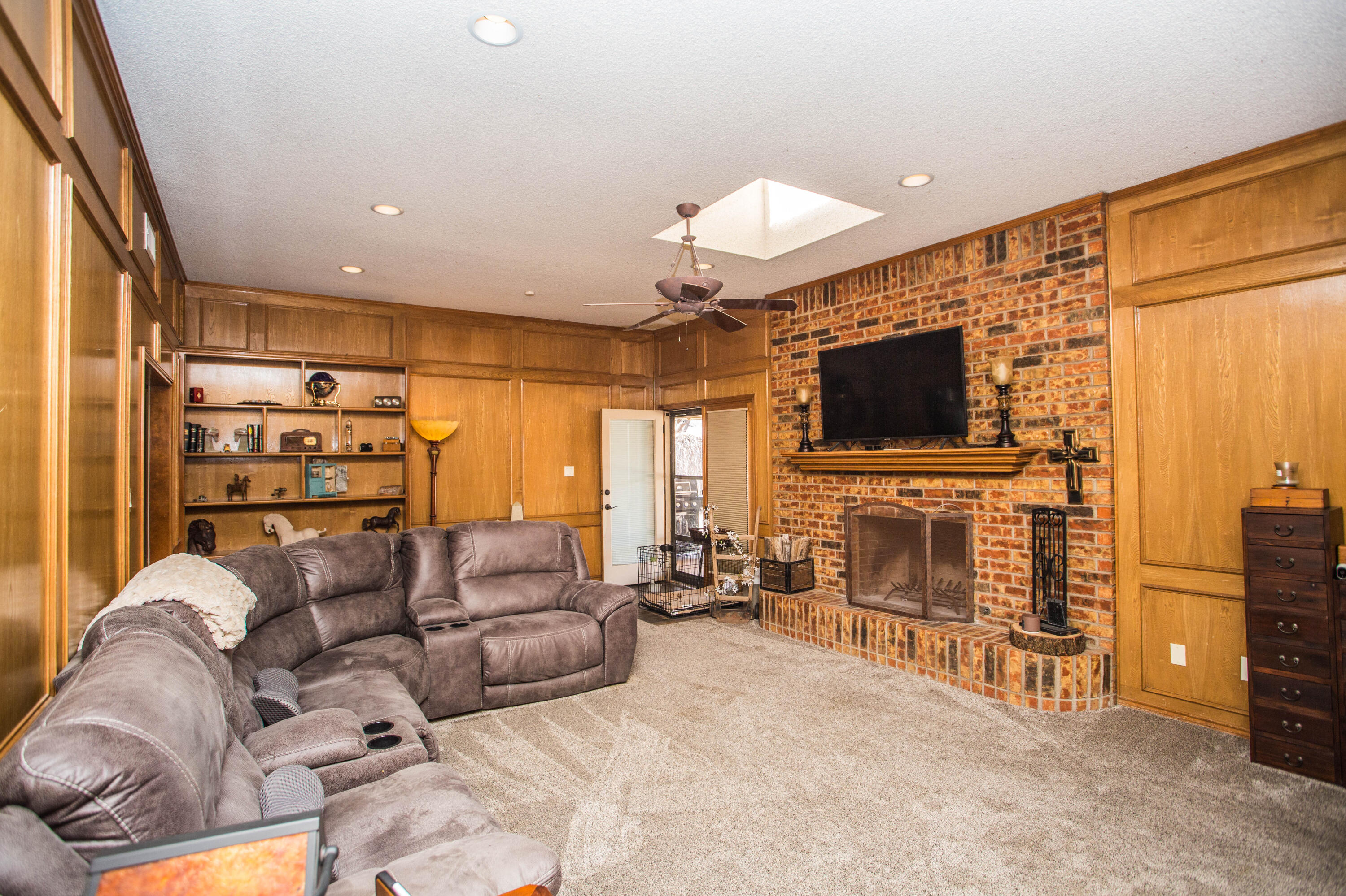 5202 85th Street Lubbock, TX 79424 - Photo 7 of 40 a living room with furniture and a flat screen tv