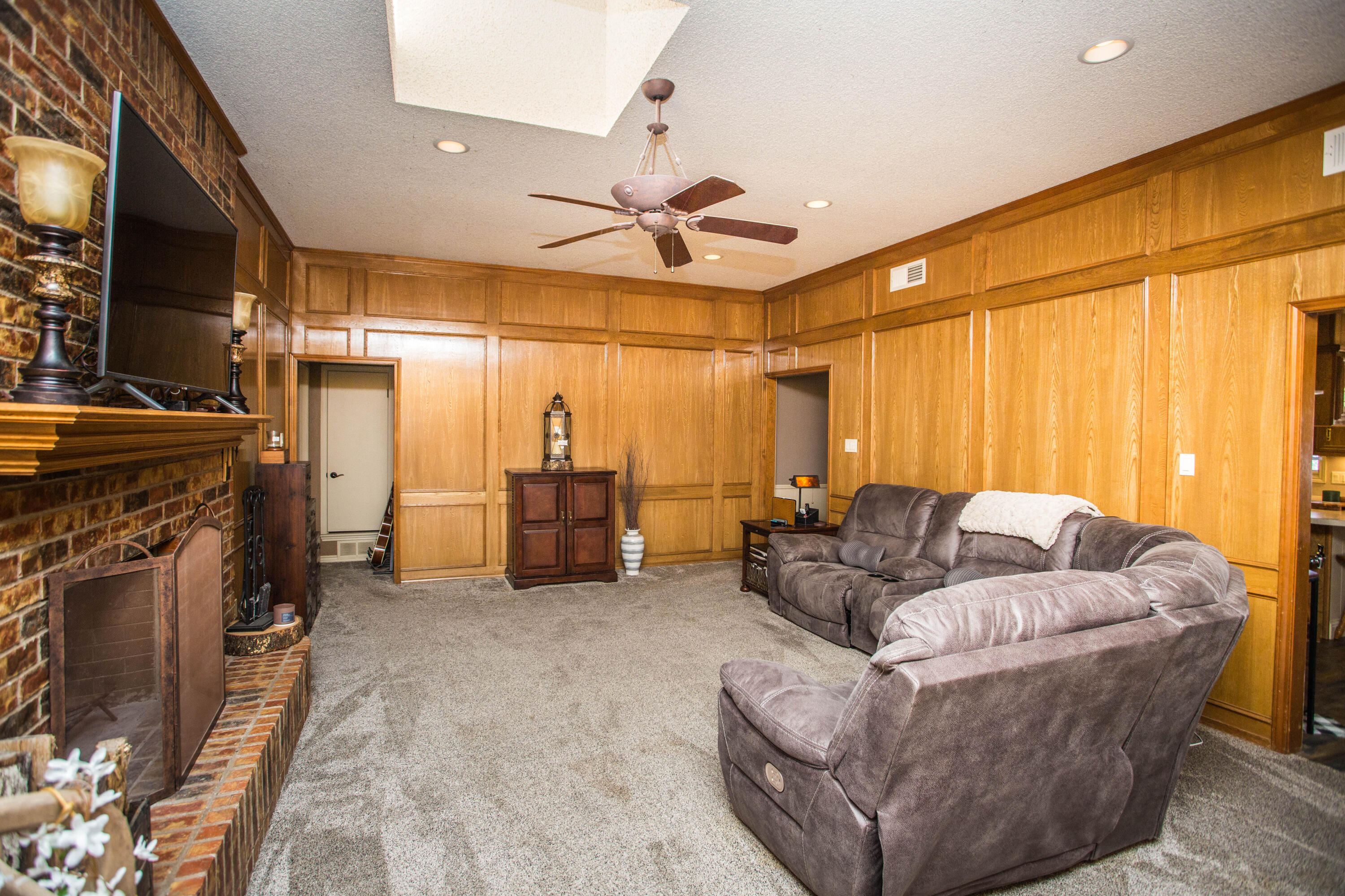 5202 85th Street Lubbock, TX 79424 - Photo 8 of 40 a living room with furniture and a fireplace